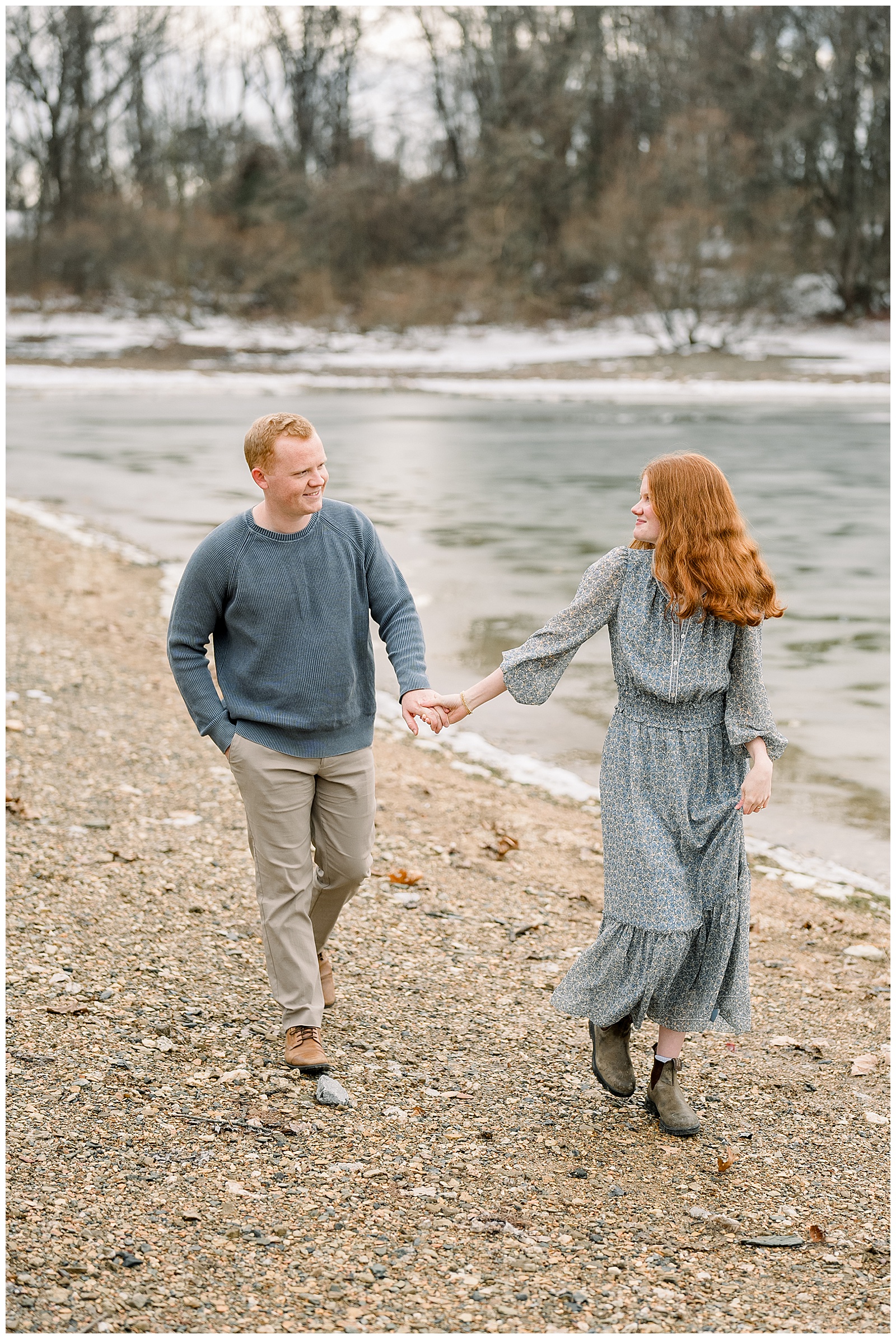 woman holding the hand of her man as she leads him along the shore for this Codorus State Park Engagement Session