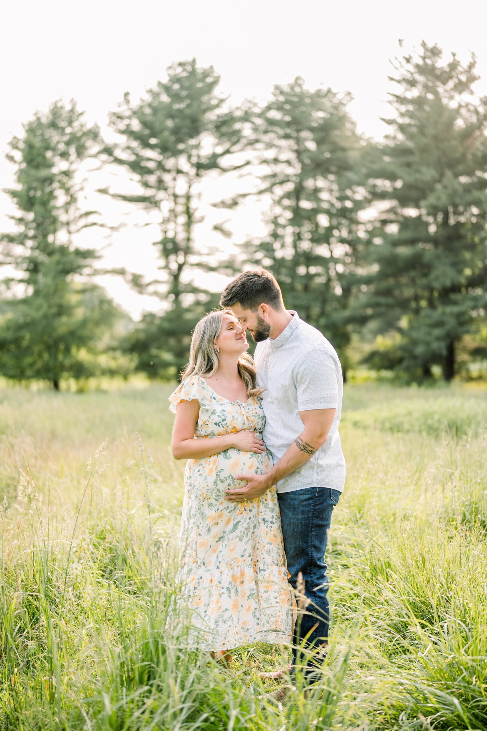 couple almost kissing as they both hold woman's pregnant belly for this Rosmajz Maternity Session